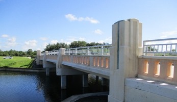 Photo of the side of a stone bridge over a river